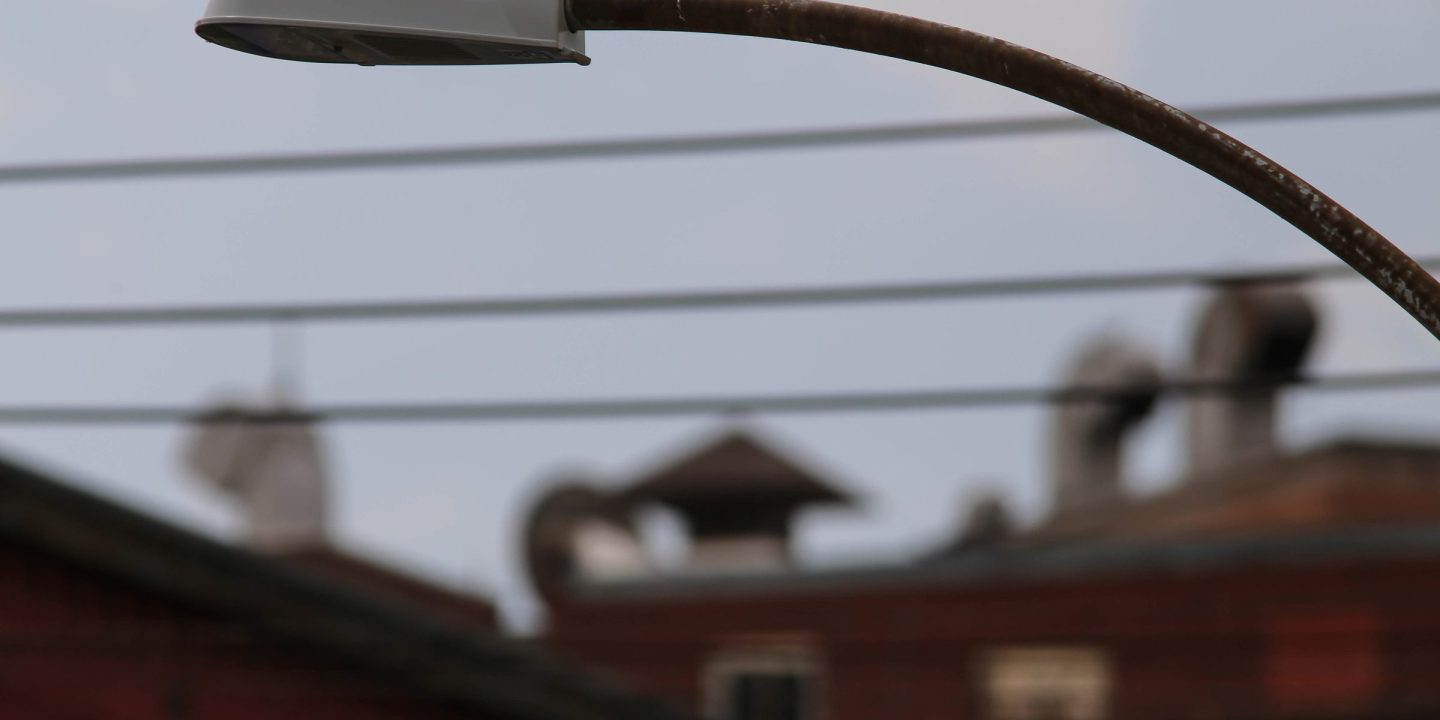 A modern LED street light against the evening sky.