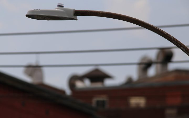 A modern LED street light against the evening sky.